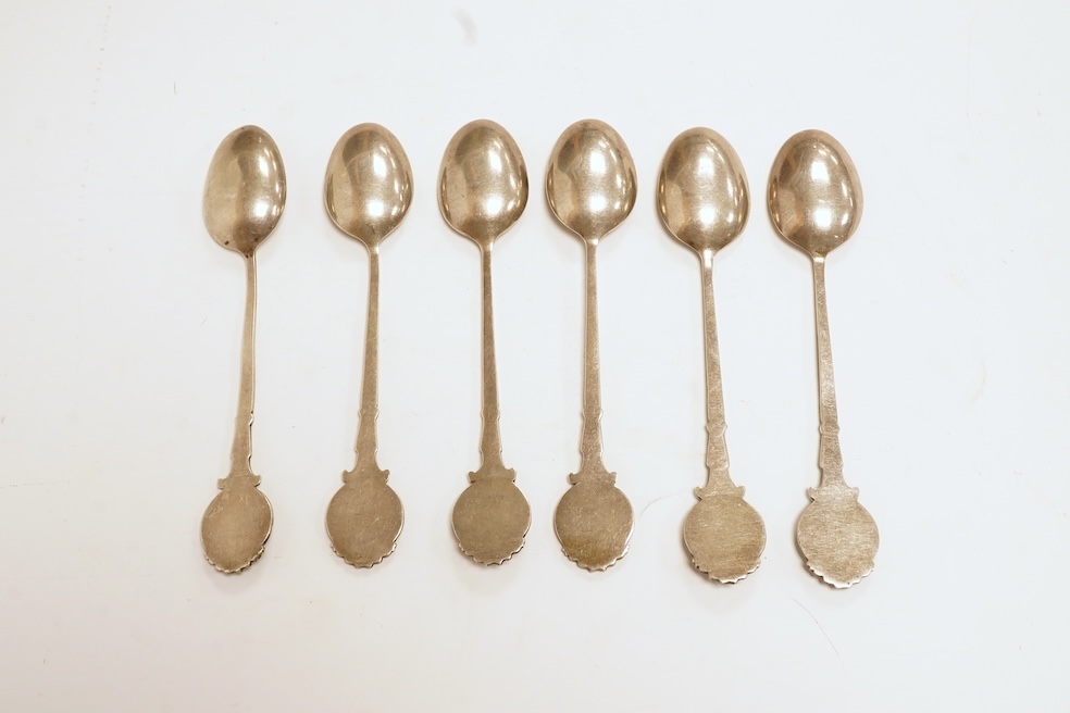 A matched set of six mainly George V silver/white metal and enamel teaspoons, with terminals decorated with dog's heads, 13.6cm. Condition - fair